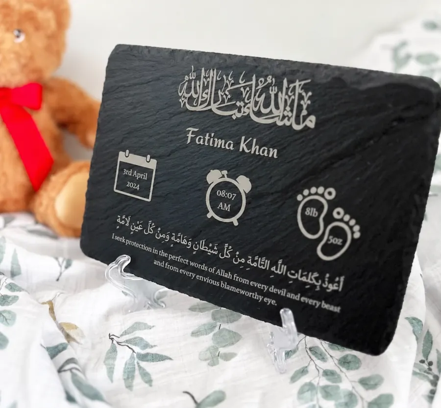 New baby birth details slate beside a teddy bear