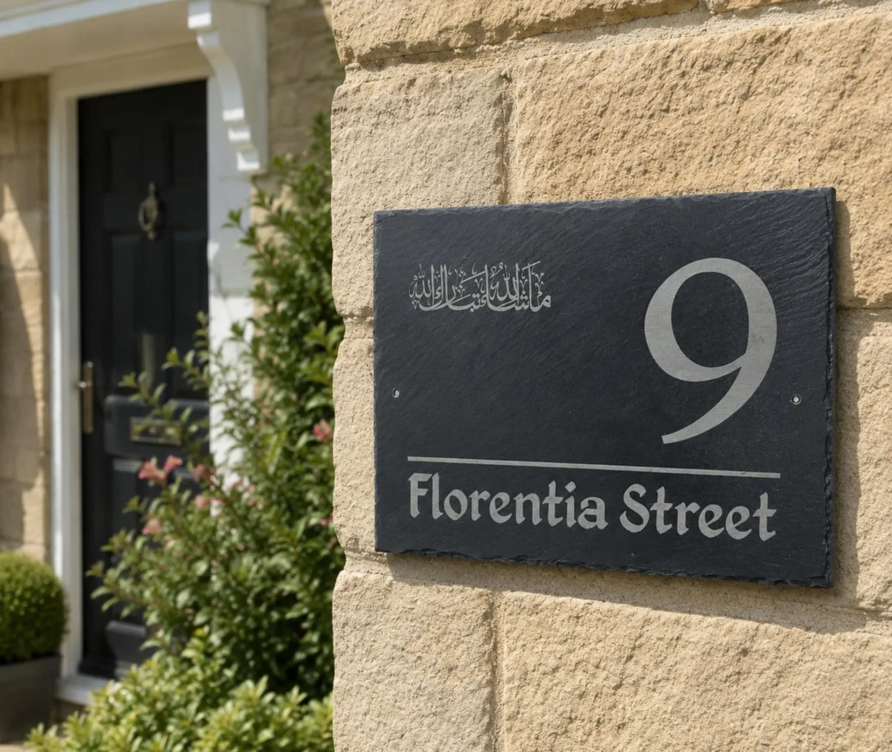 Slate door sign engraved with a house number and street name