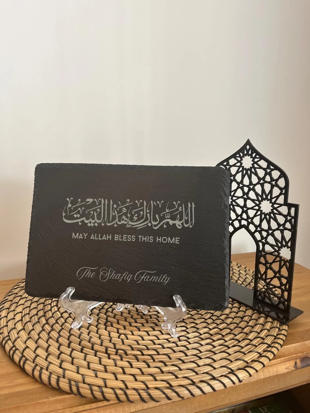 An engraved slate displayed on its clear stand