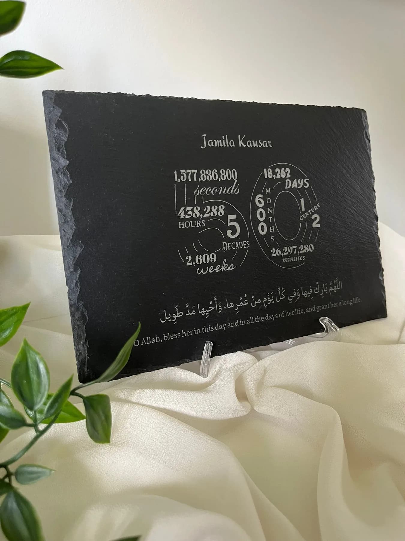 An engraved Alif & Stone slate on display